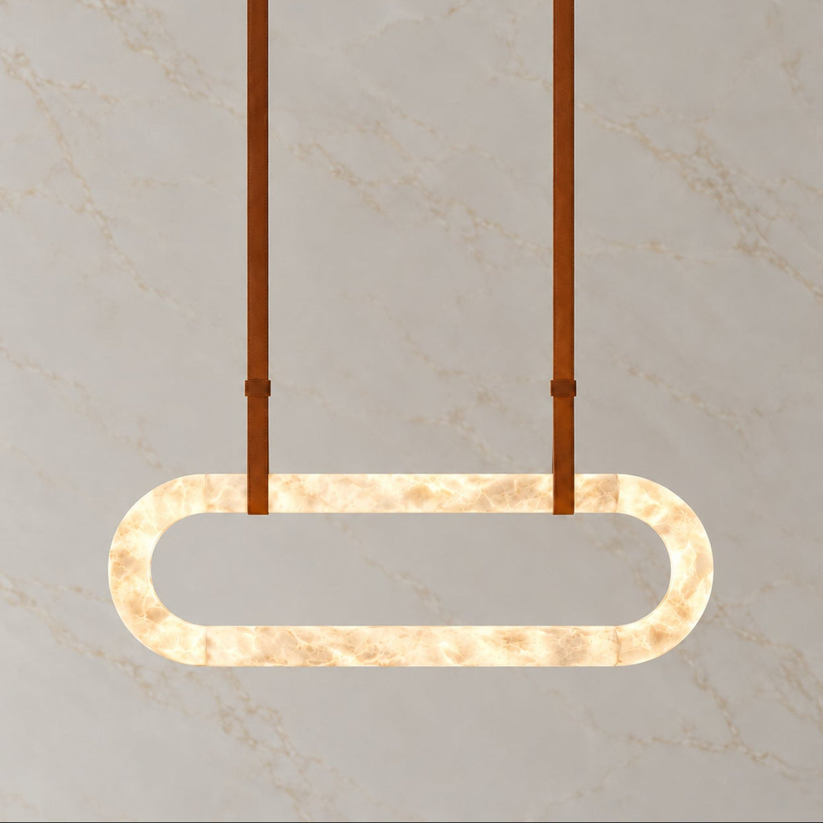 Kova Alabaster Leather Oval Chandelier vertical brown, light on | CARRA HOME