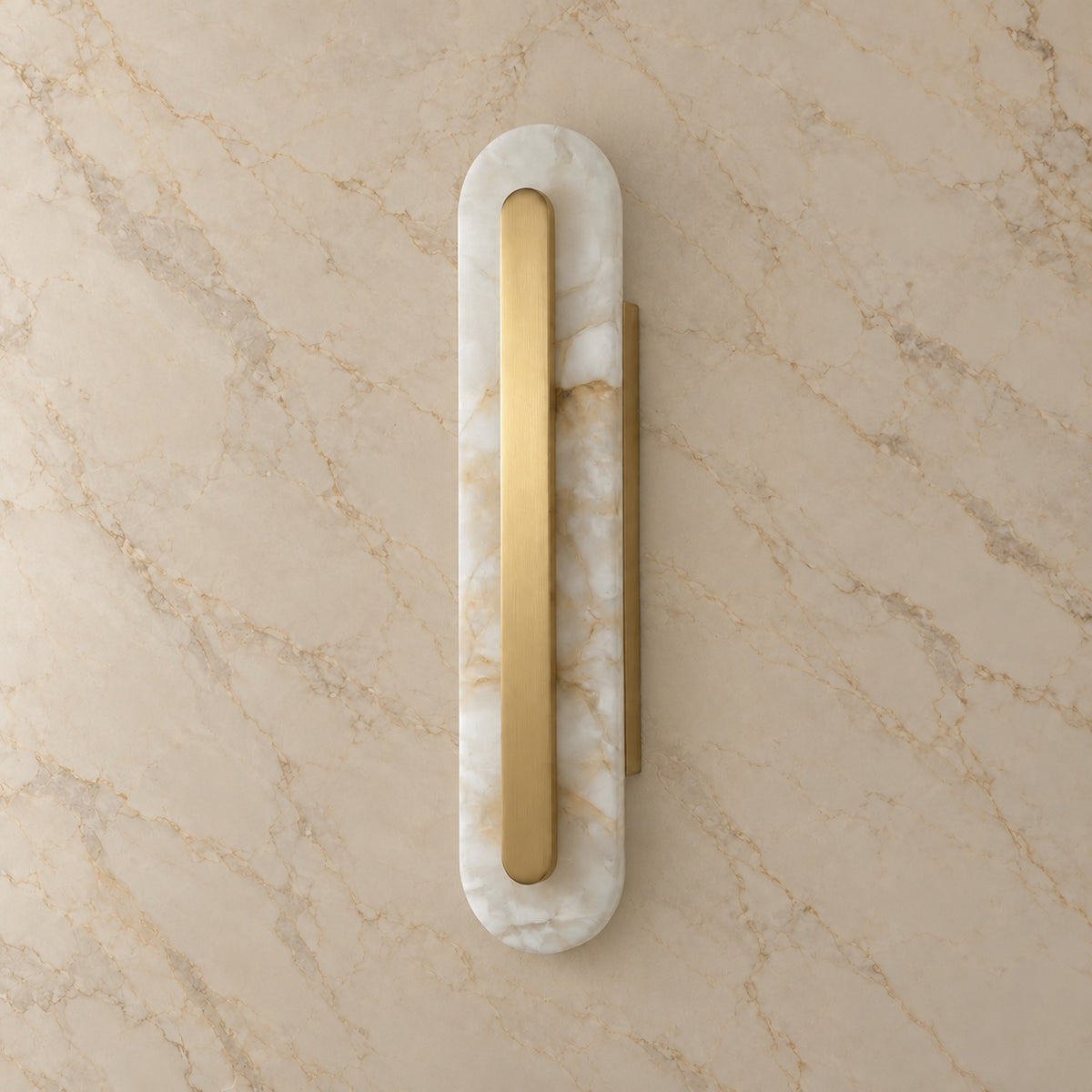 Lofos Alabaster Oval Wall Sconce with gold hardware, switched off, on a marble wall | CARRA HOME
