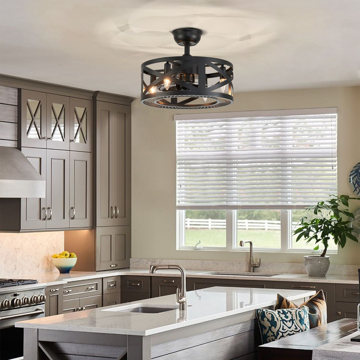 Industrial caged fan over kitchen island — gray cabinetry, white countertop, window blinds, greenery, modern farmhouse kitchen | CARRA HOME
