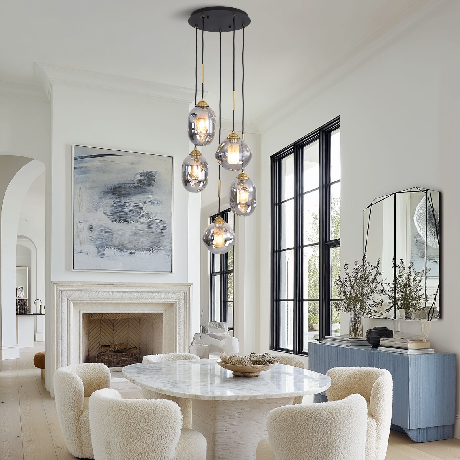 Nova Lava Glass Cascading Chandelier in a sunlit dining room — floor-to-ceiling windows, white walls, and a serene coastal view, complementing the chandelier’s glow