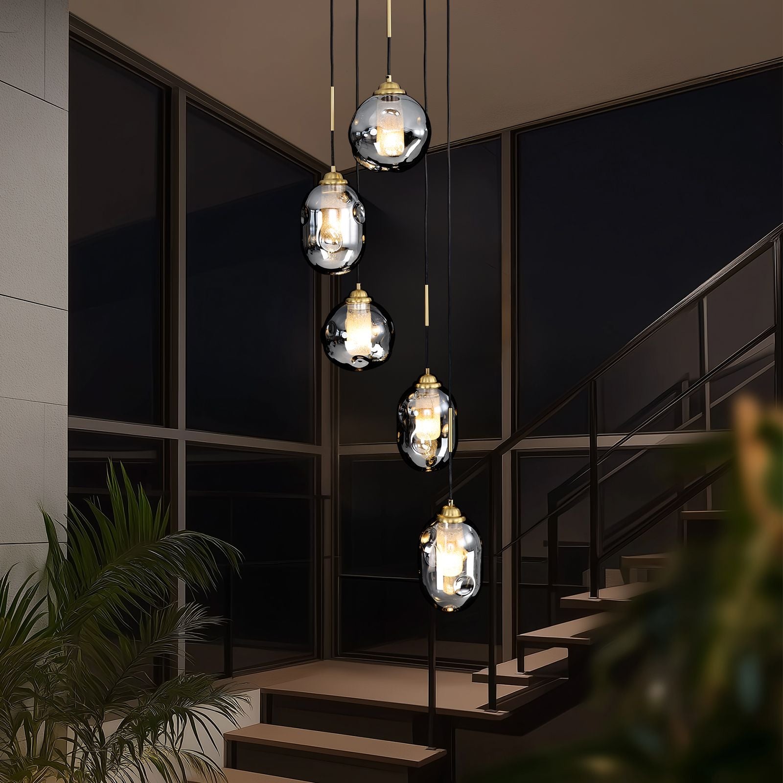 Nova Lava Glass Cascading Chandelier in a modern staircase — glass railings, dark steps, and sunset views, highlighting the chandelier’s sculptural design