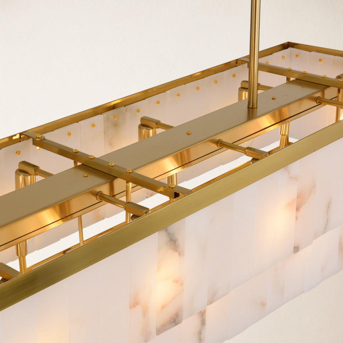 Gold frame and natural alabaster panel construction detail | CARRA HOME