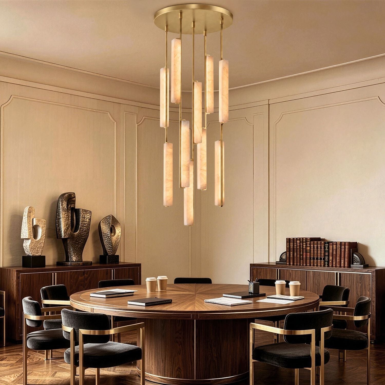 Stamen Modern Minimalist Alabaster Vertical Chandelier in a commercial conference room — hanging above a circular wooden table with modern decor, bookshelves, and sophisticated lighting-carra-home