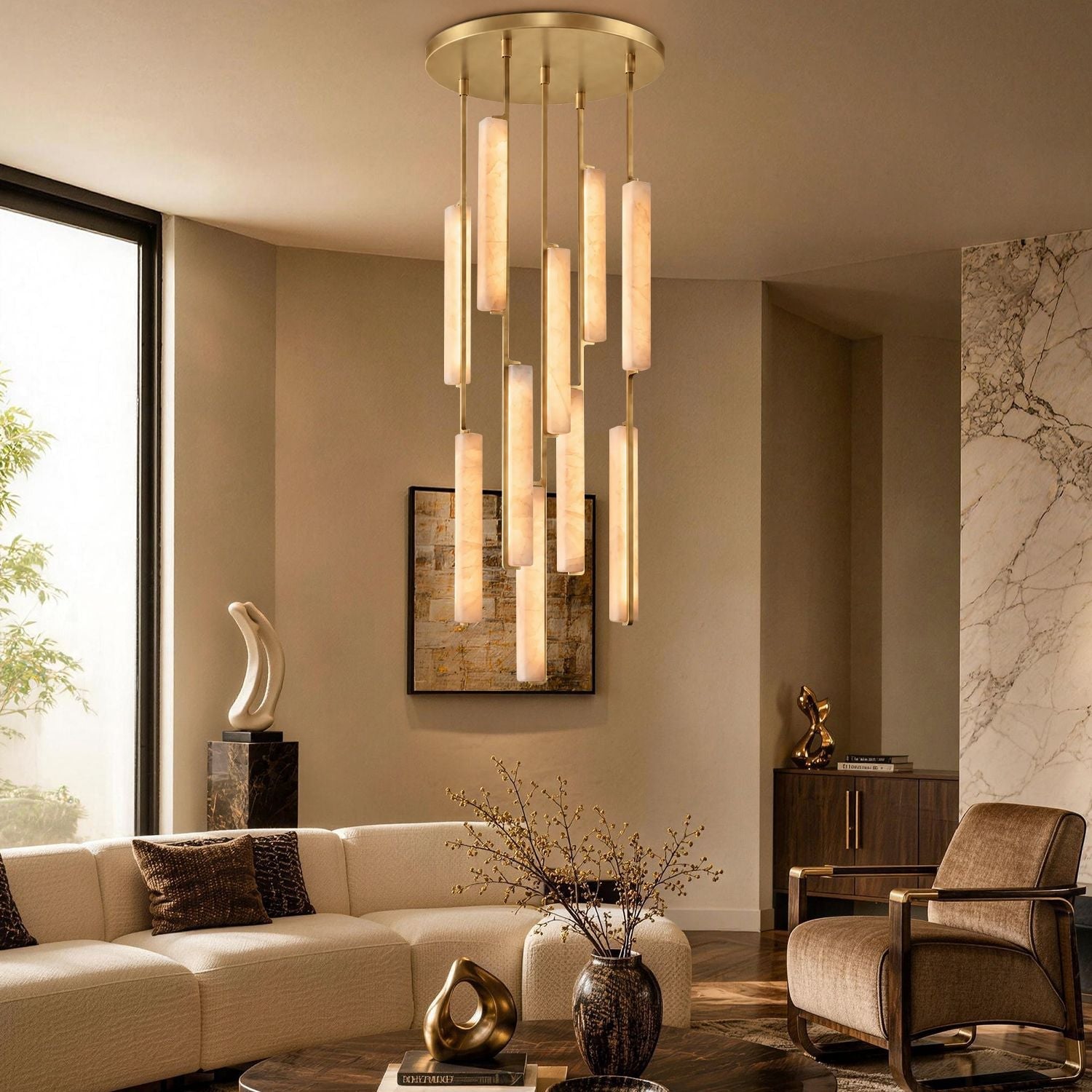 Stamen Modern Minimalist Alabaster Vertical Chandelier in a luxurious living room — hanging above a beige sofa with decorative sculptures, a large abstract painting, and natural light from tall windows-carra-home