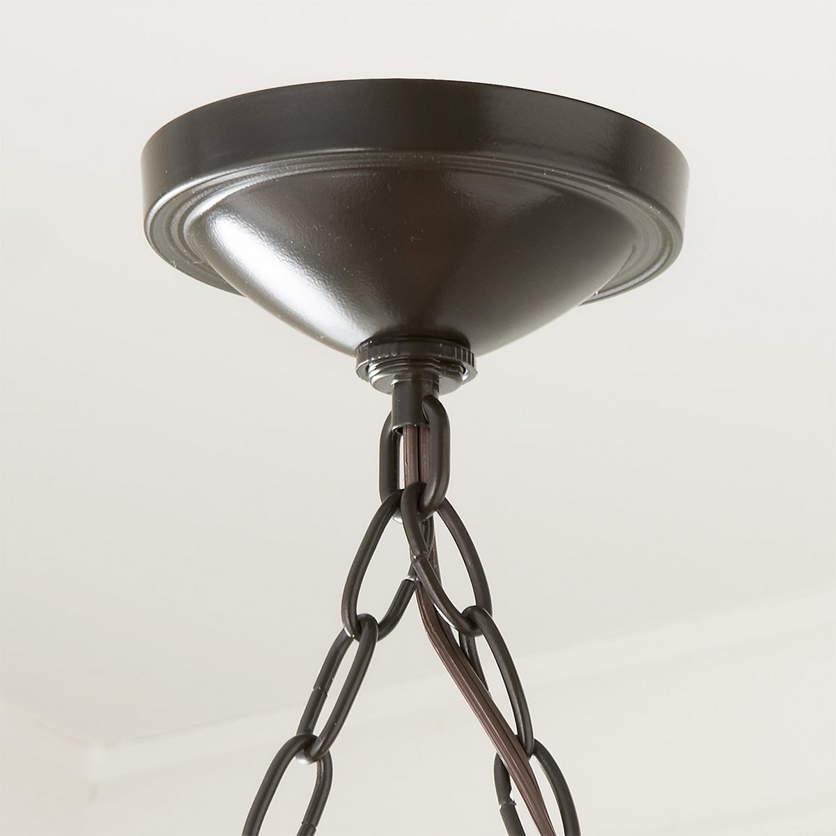 Stark bronze round ceiling canopy and shared chain junction close-up | CARRA HOME