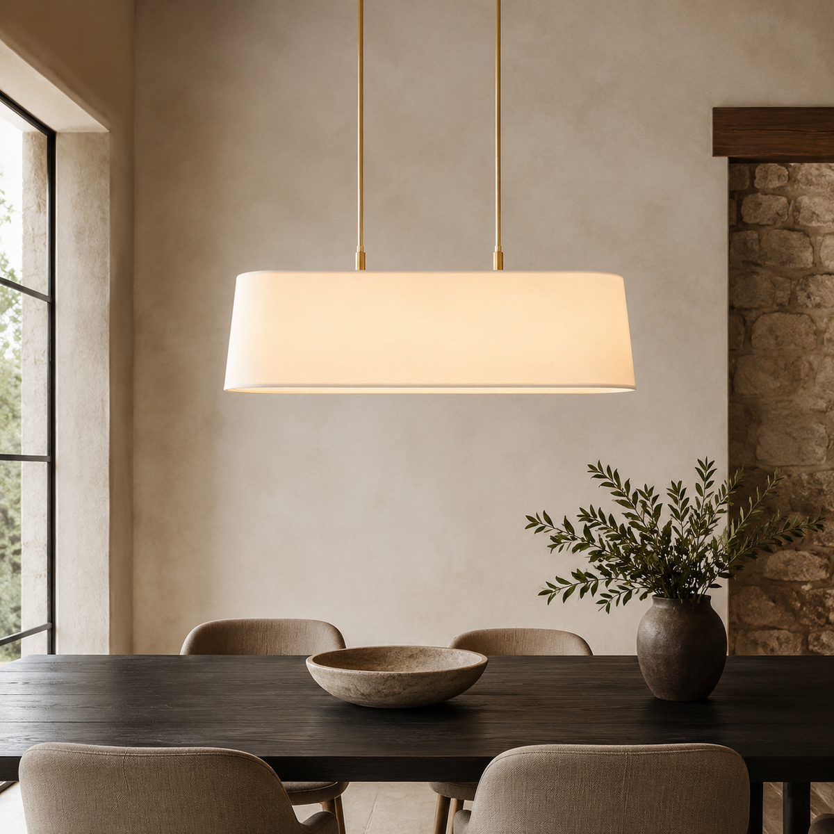 Stark Metal Linear Chandelier in gold above a walnut dining table