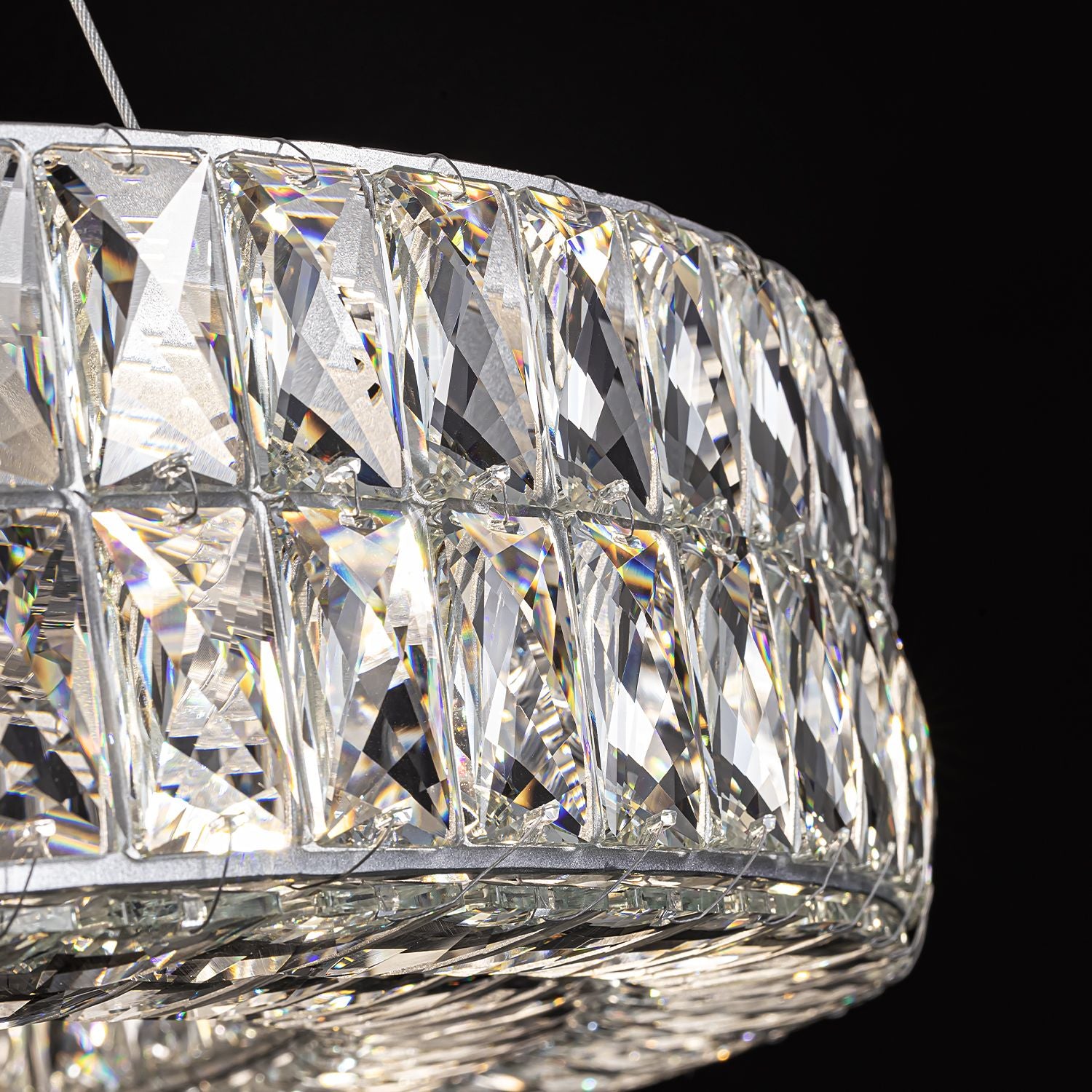 Close-up of Valdore’s silver-finished crystal frame — precision-cut prisms, sleek metal structure, and light refraction creating dazzling rainbow sparkle against black background | Carra Home