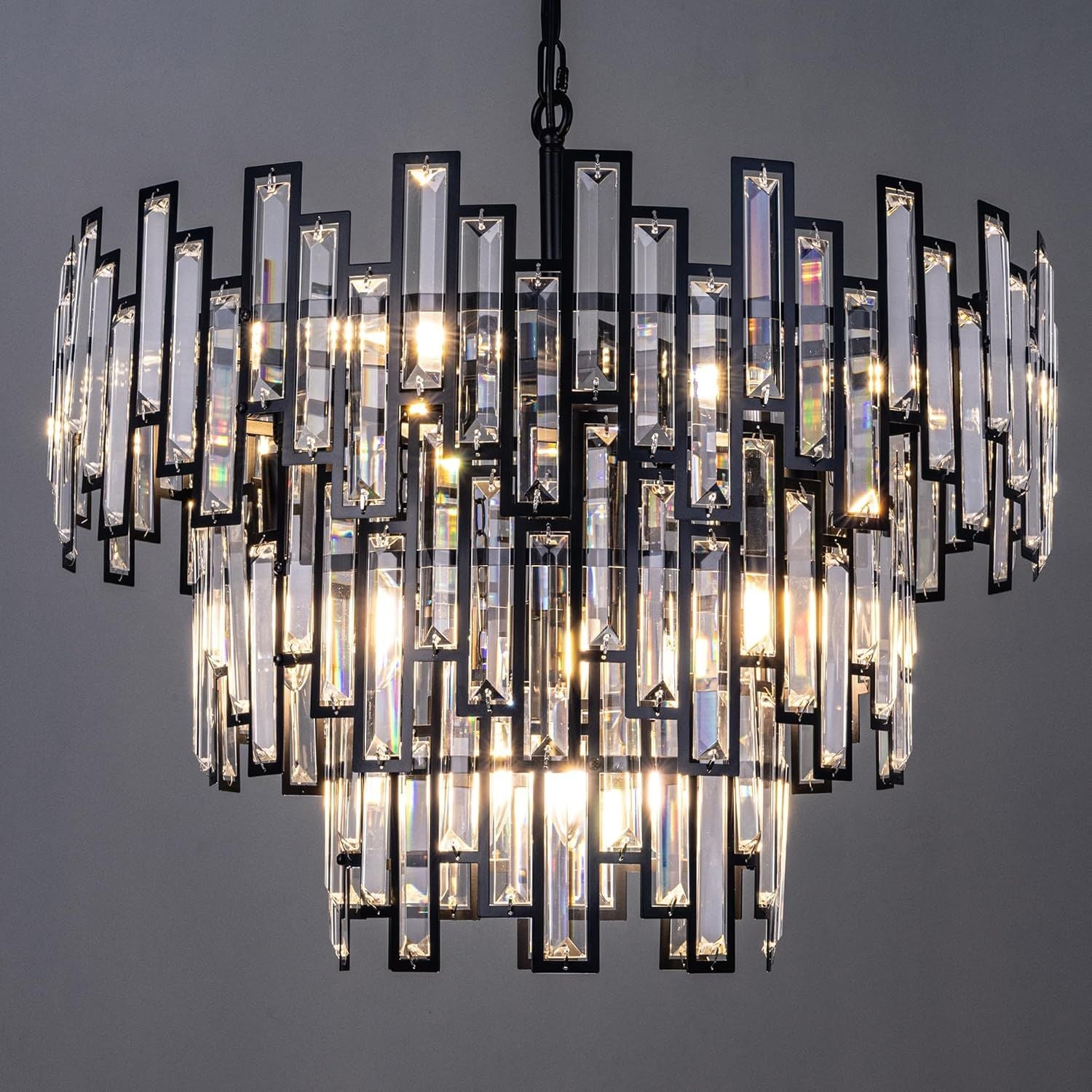 Close-up of Vera Crystal Prism Tiered Chandelier — showcasing rectangular K9 crystal prisms, black metal framework, and light refraction | Carra Home