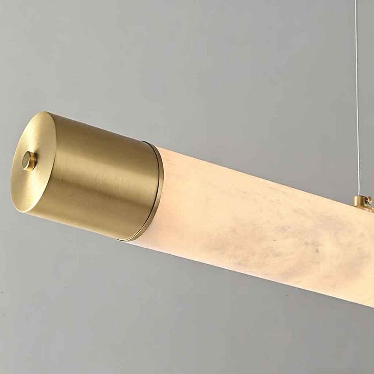 Virel Alabaster Linear Chandelier — Natural alabaster tube and brushed gold end cap detail | CARRA HOME